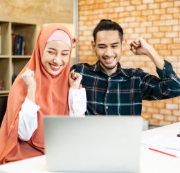 Beautiful arab businesswoman in hijab looking at camera and smiling while working in office. business woman working and at conference.Professional colleague and teamwork concept in modern people.